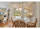 Breakfast nook with a glass table offers views of the lanai, pool, and backyard at 5164 Golf Club Ln, Spring Hill, FL 34609