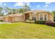 Inviting home with a three-car garage, brick accents, manicured lawn, and a well-kept yard at 5164 Golf Club Ln, Spring Hill, FL 34609
