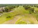 Scenic aerial view of a golf course with lush fairways and mature trees at 5164 Golf Club Ln, Spring Hill, FL 34609