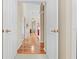 Inviting hallway featuring hardwood floors and arched entryways at 5164 Golf Club Ln, Spring Hill, FL 34609