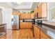 Bright kitchen boasts stainless steel appliances, ample wood cabinets and countertop space at 5164 Golf Club Ln, Spring Hill, FL 34609