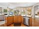 Bright kitchen island with stainless steel appliances and views of the pool and outdoor living area at 5164 Golf Club Ln, Spring Hill, FL 34609