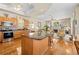 Spacious kitchen featuring stainless steel appliances, a large island, and hardwood floors at 5164 Golf Club Ln, Spring Hill, FL 34609