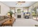 Cozy living room featuring a fireplace and sliding glass doors with serene outdoor views at 5164 Golf Club Ln, Spring Hill, FL 34609