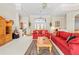 Bright living room with high ceilings, large windows, and comfortable seating arrangement at 5164 Golf Club Ln, Spring Hill, FL 34609