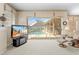 Light-filled living room showcases pool views through sliding glass doors and a cozy seating area at 5164 Golf Club Ln, Spring Hill, FL 34609