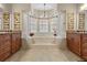 Elegant bathroom with chandelier, garden tub, and dual sinks at 5164 Golf Club Ln, Spring Hill, FL 34609