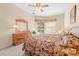 Cozy Primary bedroom with dresser, ceiling fan, and pool views at 5164 Golf Club Ln, Spring Hill, FL 34609