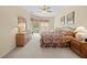 Spacious Primary bedroom with a ceiling fan and view of the pool at 5164 Golf Club Ln, Spring Hill, FL 34609