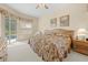 Comfortable Primary bedroom featuring a ceiling fan and pool view at 5164 Golf Club Ln, Spring Hill, FL 34609