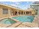 Inviting screened-in pool area featuring a spa and an outdoor seating area, perfect for relaxation at 5164 Golf Club Ln, Spring Hill, FL 34609