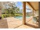 Covered patio featuring a screened-in pool area with brick pavers and outdoor seating at 5164 Golf Club Ln, Spring Hill, FL 34609