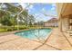 Relaxing screened-in pool area with a spa, ideal for enjoying outdoor living at 5164 Golf Club Ln, Spring Hill, FL 34609