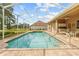 Private screened-in pool offering a relaxing outdoor retreat, and features an outdoor kitchen area at 5164 Golf Club Ln, Spring Hill, FL 34609