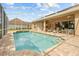 Enjoy the outdoors in this screened-in pool with a spa and an outdoor kitchen for entertaining at 5164 Golf Club Ln, Spring Hill, FL 34609