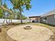 Back yard features a fire pit, hammocks, pergola with table and chairs and lots of privacy at 5341 Birchwood Rd, Spring Hill, FL 34608