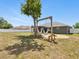 A cozy backyard featuring a hammock swing and a fire pit area for relaxation at 5341 Birchwood Rd, Spring Hill, FL 34608
