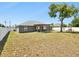 Spacious backyard featuring a cozy pergola and a well-maintained privacy fence at 5341 Birchwood Rd, Spring Hill, FL 34608
