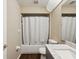 This bathroom has a marble countertop, shower with curtain and toilet at 5341 Birchwood Rd, Spring Hill, FL 34608
