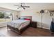 Bedroom featuring hardwood floor, ceiling fan, and a window providing natural light at 5341 Birchwood Rd, Spring Hill, FL 34608