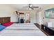 Bedroom featuring hardwood floor, ceiling fan, television, and natural light from the window at 5341 Birchwood Rd, Spring Hill, FL 34608