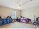 Bedroom has an ceiling fan and window and a dresser with some decorative accessories at 5341 Birchwood Rd, Spring Hill, FL 34608