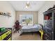 A cozy bedroom features a ceiling fan, closet, and an exterior view from a window at 5341 Birchwood Rd, Spring Hill, FL 34608