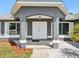Inviting front entrance with double doors, decorative pillars, and manicured landscaping at 5341 Birchwood Rd, Spring Hill, FL 34608