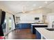 This open kitchen offers stainless appliances, wood floors, custom cabinetry, and an island with sink at 5341 Birchwood Rd, Spring Hill, FL 34608