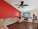 Cozy living room with a plush sofa, media center, and ceiling fan at 5341 Birchwood Rd, Spring Hill, FL 34608