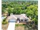 An aerial view of the home with lush trees at 5378 Mosquero Rd, Spring Hill, FL 34606
