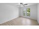 Bedroom featuring two windows and wood-look floors at 5378 Mosquero Rd, Spring Hill, FL 34606