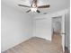 This bedroom features neutral walls, wood-look flooring, and a ceiling fan at 5378 Mosquero Rd, Spring Hill, FL 34606