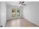 Bedroom with wood-look floors and two windows at 5378 Mosquero Rd, Spring Hill, FL 34606