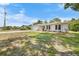 Single-story home with a well manicured lawn and lots of trees at 5378 Mosquero Rd, Spring Hill, FL 34606