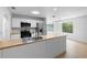 Bright, open kitchen with stainless steel appliances and modern butcher block countertops at 5378 Mosquero Rd, Spring Hill, FL 34606