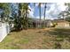 Large backyard featuring an enclosed screened porch at 5638 Hereford Dr, New Port Richey, FL 34655