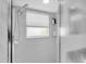 Modern bathroom features a tiled shower with dual shower head and glass door at 5638 Hereford Dr, New Port Richey, FL 34655