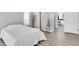 Bedroom showcasing light walls and wood floors leading to an open doorway at 5638 Hereford Dr, New Port Richey, FL 34655