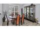 The dining area features hardwood floors, a stone table, and a beautiful display cabinet at 5638 Hereford Dr, New Port Richey, FL 34655