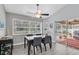 Cozy dining room with ceiling fan, view to the backyard, and direct access to the pool and patio at 5638 Hereford Dr, New Port Richey, FL 34655