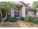 Inviting front entrance with decorative glass doors and lush tropical landscaping at 5638 Hereford Dr, New Port Richey, FL 34655