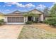Charming single-story home features a two-car garage and mature landscaping, enhancing its curb appeal at 5638 Hereford Dr, New Port Richey, FL 34655