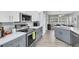 Modern kitchen features gray and white cabinets, stainless steel appliances, and sleek countertops at 5638 Hereford Dr, New Port Richey, FL 34655