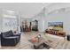 Bright living room featuring vaulted ceilings, wood floors, and a comfortable seating area at 5638 Hereford Dr, New Port Richey, FL 34655