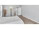 Main bedroom featuring gray walls, plank flooring, natural lighting, and an ensuite bathroom at 5638 Hereford Dr, New Port Richey, FL 34655