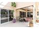 Covered patio area with comfortable seating and multiple sliding glass doors for indoor-outdoor living at 5638 Hereford Dr, New Port Richey, FL 34655