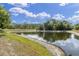 Scenic view of the community pond surrounded by lush greenery at 5638 Hereford Dr, New Port Richey, FL 34655