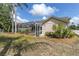 View of home with screen enclosed porch, mulch landscaping, and lawn at 5638 Hereford Dr, New Port Richey, FL 34655