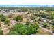 Overhead view of property, showing home, surrounding roads and mature trees surrounding the landscape at 6203 Sumter Dr, Brooksville, FL 34602